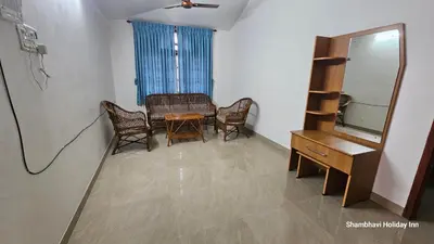 a dining room with a table and chairs and a mirror at SHI's Alaya 3BHk Villa in Coimbatore, near Railway station in Pīlamedu