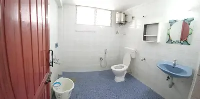 a bathroom with a toilet and a sink at SHI's Alaya 3BHk Villa in Coimbatore, near Railway station in Pīlamedu