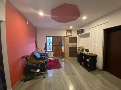a living room with a chair and a desk at S VILLA in Wayanad