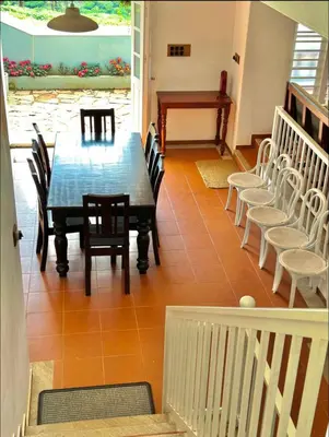 a dining room with a table and chairs at THALIMALA BUNGALOW in Vythiri