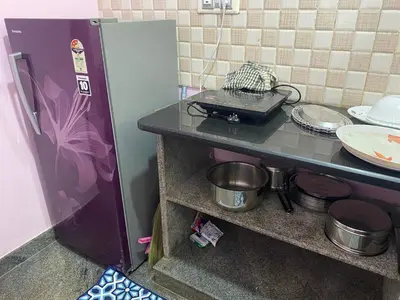 a kitchen with a counter with pots and pans at Lovely Private Queen Bed Room in Shared 2 BHK Apartment in Mysore