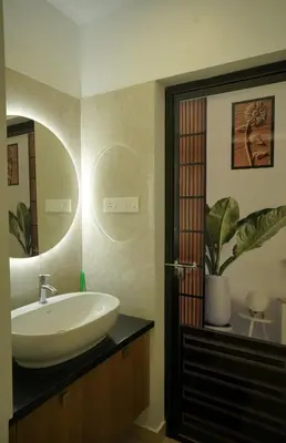 a bathroom with a sink and a mirror at Luxury Homes - Cochin Airport - Nedumbassery in Angamali