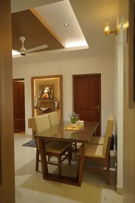 a dining room with a wooden table and chairs at Luxury Homes - Cochin Airport - Nedumbassery in Angamali