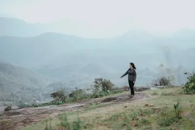 a person standing on top of a hill at Qatsyir Horizon in Varagampadi