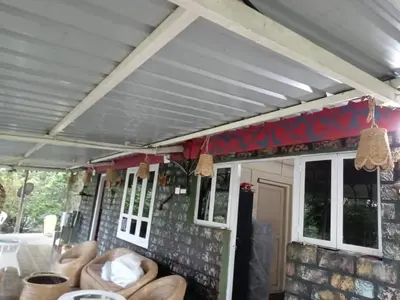 a covered porch with couches on a house at Qatsyir Horizon in Varagampadi