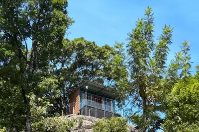 a building on top of a hill with trees at Qatsyir Horizon in Varagampadi