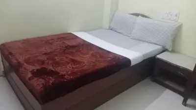a small bed in a small room with at MYSORE MAHALAKSHMI ROOMS in Mysore