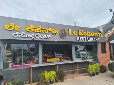 a restaurant with a sign on the front of it at Mannat Inn TS Mysore - Family Homestay in Mysore