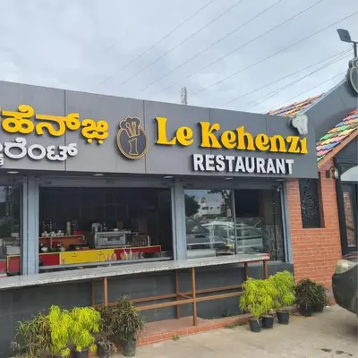 a restaurant with a sign that reads le klearras restaurant at Mannat Inn TS Mysore - Family Homestay in Mysore