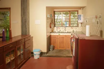 a kitchen with a sink and a window in it at Villa in the woods in Trichūr