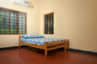 a bedroom with a wooden bed in a room at Villa in the woods in Trichūr