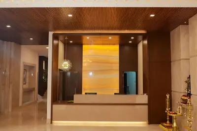 a lobby with a reception desk in a building at Hotel Turmeric in Erode