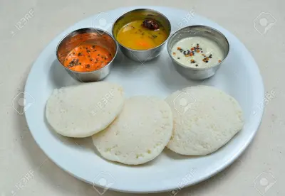 a plate of food with chapatis and two bowls of soup at Fortune Inn in Erode