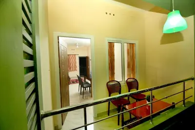 a room with a balcony with chairs and a hallway at LOYAL RESIDENCY in Sultan Bathery