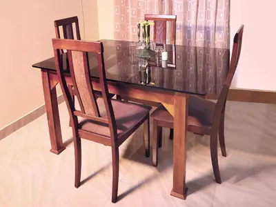 a dining room table with two chairs and a black table and chairsuggest at LOYAL RESIDENCY in Sultan Bathery