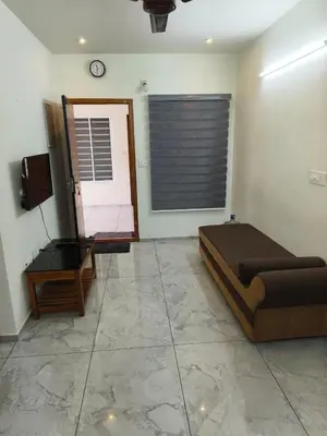a bedroom with a bed and a mirror and a television at Shams al Imarat in Palakkad