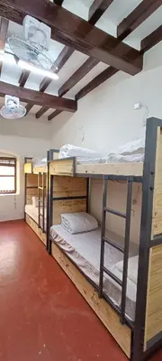 a room with three bunk beds in it at xplorest in Mysore