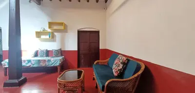 a room with chairs and a bed in a room at xplorest in Mysore