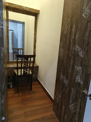 a chair in a room with a wooden wall at Beautiful 4bhk Duplex Villa in Mysore