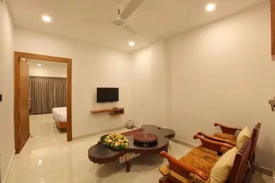 a living room with a table and a couch at HOTEL PRINCE in Kāladi