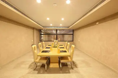 a dining room with a long wooden table and chairs at HOTEL PRINCE in Kāladi
