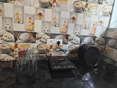 a table with plates and bowls on a wall at Downtown Service Apartments in Mysore
