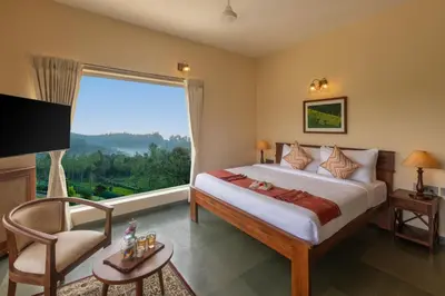a bedroom with a large bed and a large window at Solitude by Nature Resorts and Stays in Kotagiri
