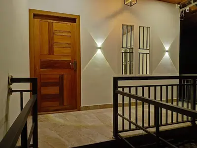 a room with a wooden door and a staircase at Paradise Homestay in Wayanad