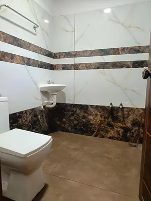 a bathroom with a toilet and a sink at Paradise Homestay in Wayanad