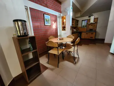 a kitchen and dining room with a table and chairs at Golden castle in Mysore