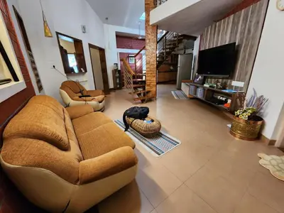 a living room with a couch and a television at Golden castle in Mysore