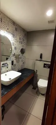 a bathroom with a sink and a toilet at SKY PENTA RESIDENCY in Iritti