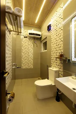 a bathroom with a toilet and a sink at Green Wood Hill Cottage in Ooty