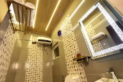 a bathroom with a sink and a mirror on the wall at Green Wood Hill Cottage in Ooty