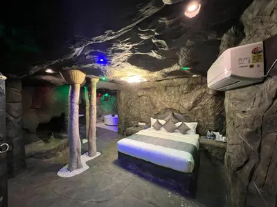 a bed in a room in a cave at Mystery Maze Resort and Spa in Wayanad