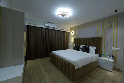 a bedroom with a large bed and a light at Mystery Maze Resort and Spa in Wayanad