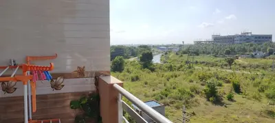 a balcony with a view of a river at Vrindavan - An Artists Nook in Mysore