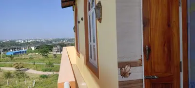 a door to a balcony with a butterfly on the window at Vrindavan - An Artists Nook in Mysore
