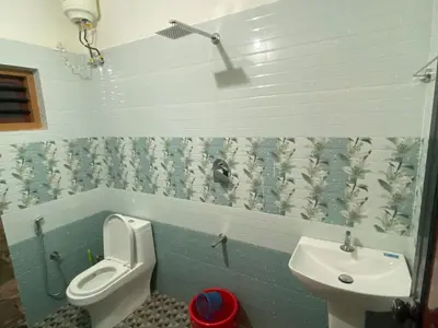 a bathroom with a toilet and a sink at HappyDays HomeStay Wayanad in Chekadi
