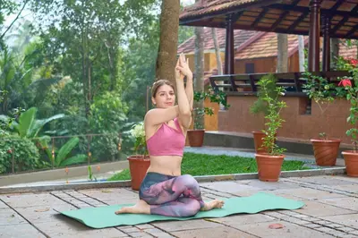 a woman doing a yoga pose on the ground at Malabar Kovilakam in Malappuram