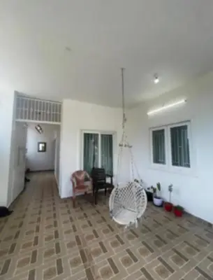 a living room with a swing in the middle of a room at White House Kotagiri, 2bhk in Kotagiri