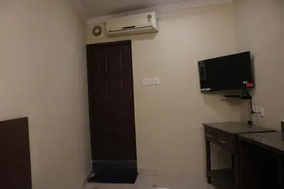 a room with a door and a heater and a television at LILLY RESIDENCY by Chungath in Perumbavoor
