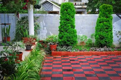 a garden with a red and black checkered floor at Vythiri Garden in Vythiri