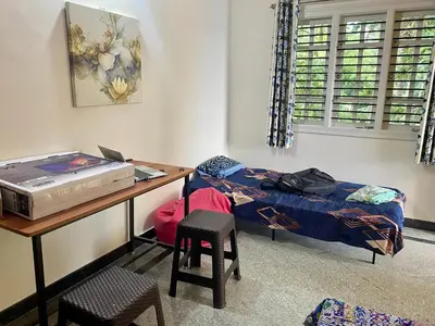 a bedroom with a desk and a bed and a table and chair at Spacious 2BHK for upto 12 Guests , Best for Families & Groups in Mysore