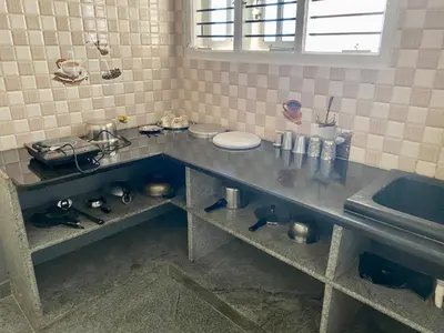 a kitchen with a counter top with a sink at Spacious 2BHK for upto 12 Guests , Best for Families & Groups in Mysore