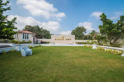 a building with a lawn in front of a building at CSR Landmark Resorts in Coimbatore