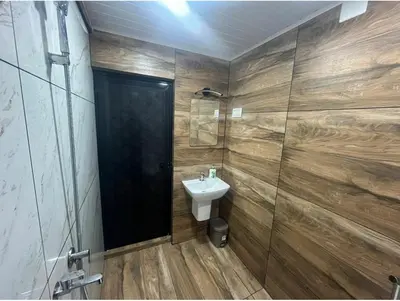 a bathroom with a sink and a glass shower at Vyshnavi home stay in Thanniyam