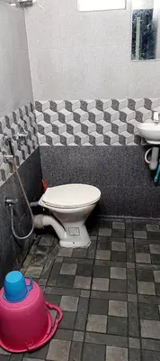 a bathroom with a toilet and a sink at JJ HOLIDAY HOMES WAYANAD in Kalpetta