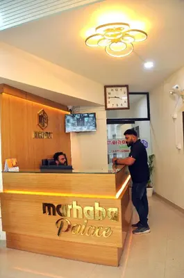 a man standing at the counter of a restaurant at MARHABA PALACE in Kozhikode