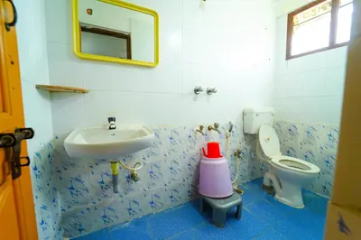 a bathroom with a sink and a toilet at AMOGHA RESIDENCY in Mysore